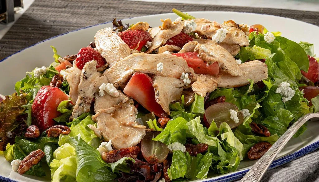 Chicken salad with strawberries, grapes, pecans, and crumbled cheese.