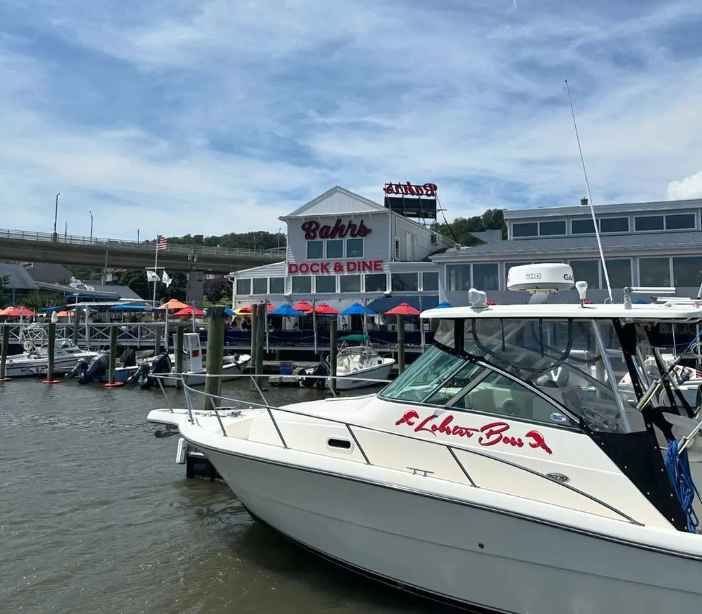 Waterfront Bahr's Dock & Dine, with Lobster Boss boat and colorful umbrellas.
