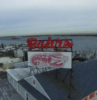 Aerial view of Bahr's red lobster sign on a waterfront building.