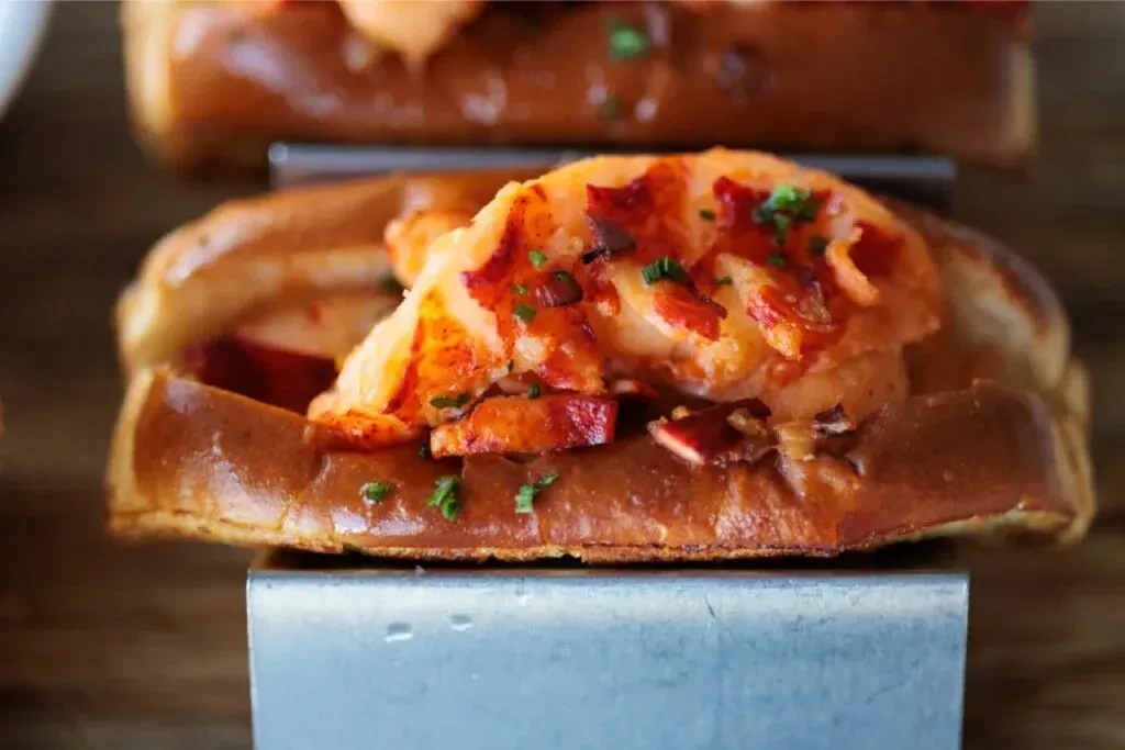 Toasted brioche bun generously filled with vibrant lobster meat and herbs.
