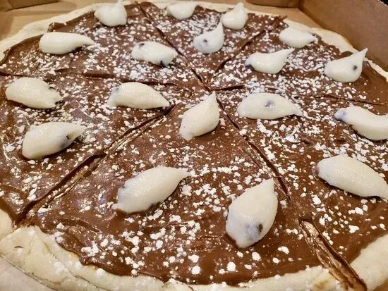 Sliced chocolate dessert pizza topped with mochi and powdered sugar.