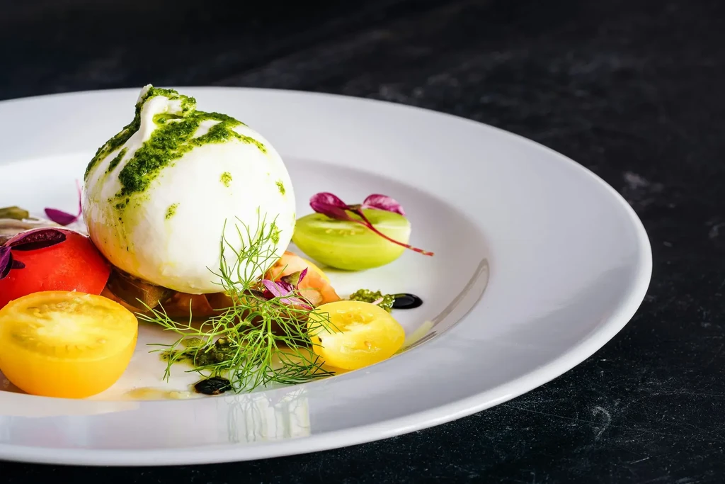 Burrata cheese with heirloom tomatoes, pesto, dill, and balsamic glaze.
