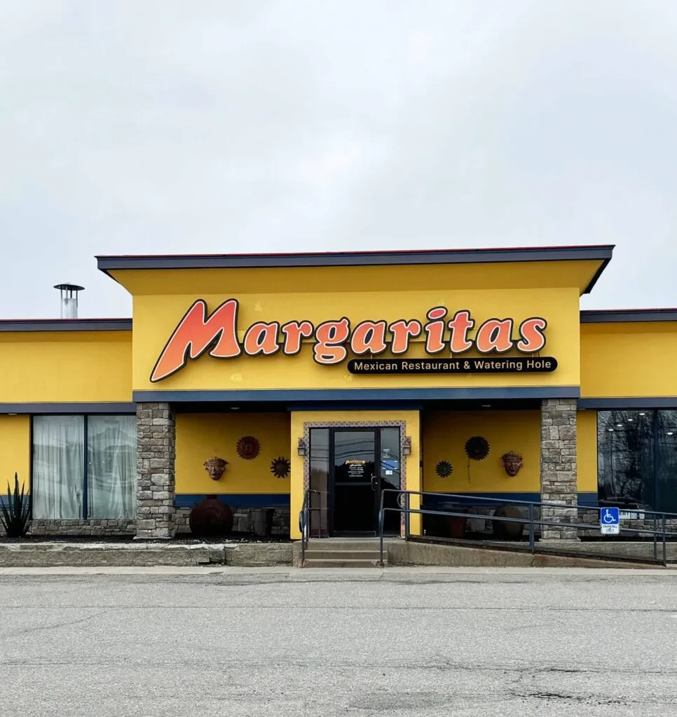 Bright yellow Margaritas Mexican Restaurant exterior features blue trim and wheelchair ramp.