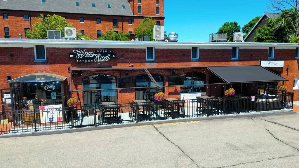 Elevated view of Mojo's West End Tavern, brick building, outdoor patio.