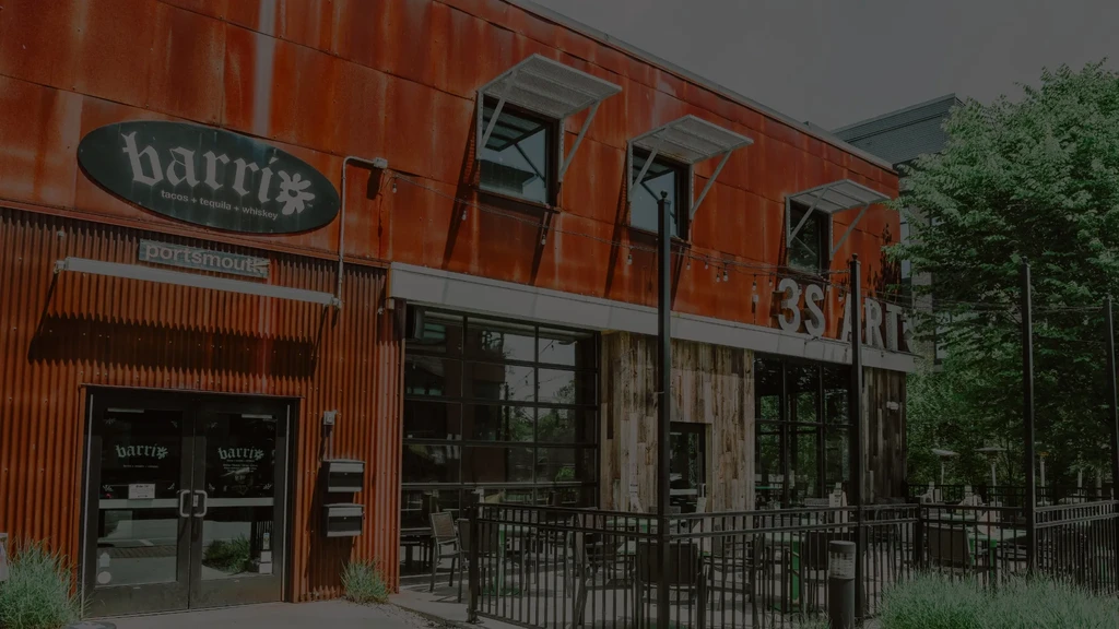 barri tacos building with corrugated metal, wood, and outdoor patio.