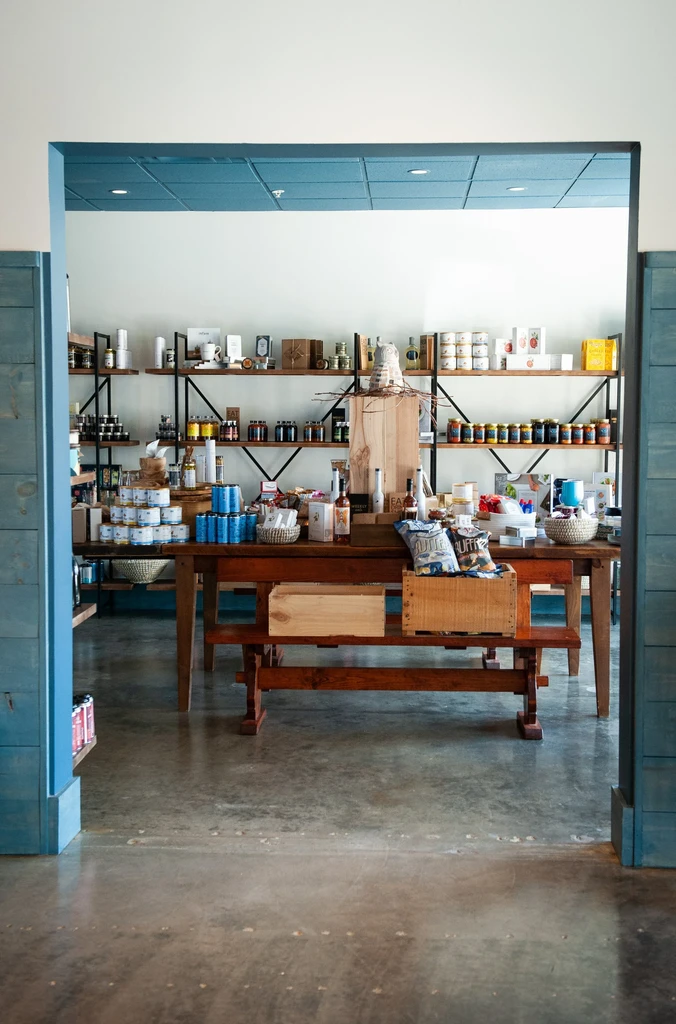 Clean, organized modern market interior displaying packaged food and drinks.