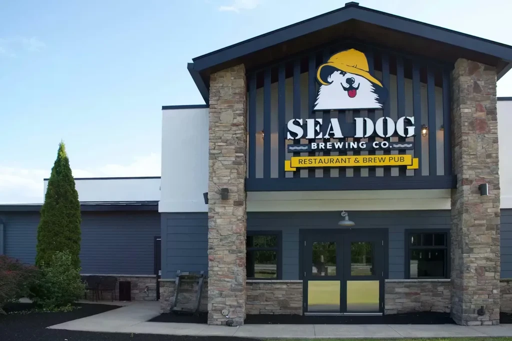 Sea Dog Brewing Co. brew pub exterior with stone entrance and blue siding.