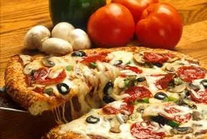 Pizza slice lifted, cheese stretching, topped with pepperoni and vegetables.