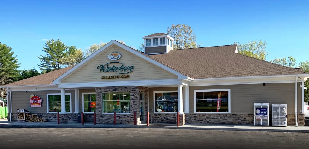 Waterboro Market & Cafe building with Krispy Krunchy Chicken sign on sunny day.