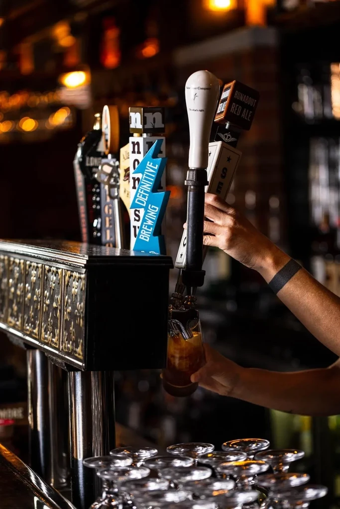 Hand pouring Runabout Red Ale from a tap into a glass.