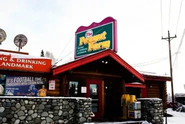 The Prospector Farm, a snowy log cabin 'eating and drinking landmark'.