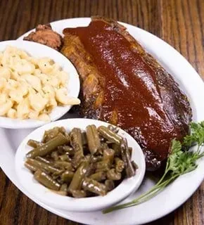 Large BBQ ribs with mac and cheese, green beans, and parsley.