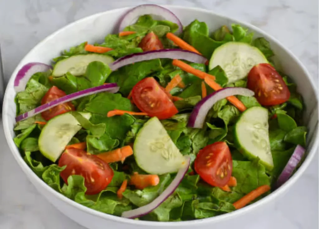 Fresh, colorful mixed vegetable salad in a white bowl.