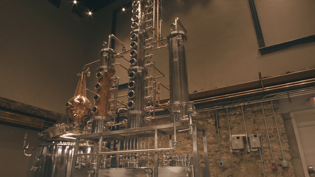 Large, shiny steel and copper distillation system with an onion still.