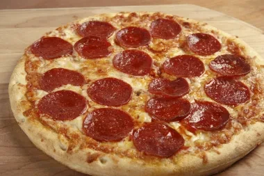 A whole, golden-crusted pepperoni pizza with melted cheese.