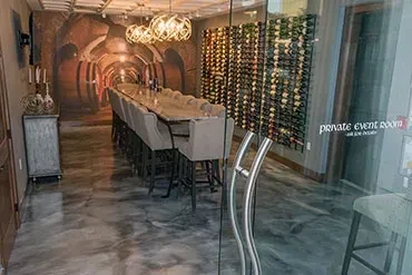 Private event room with wine barrel mural and visible wine rack.