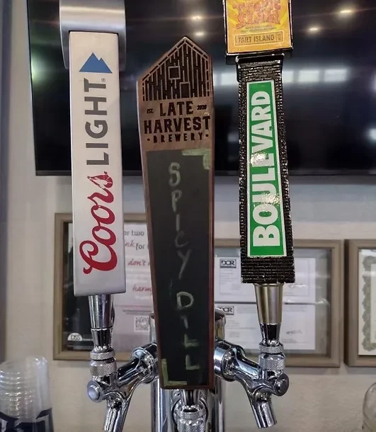 Three distinct beer tap handles: Coors Light, Spicy Dill, and Boulevard.