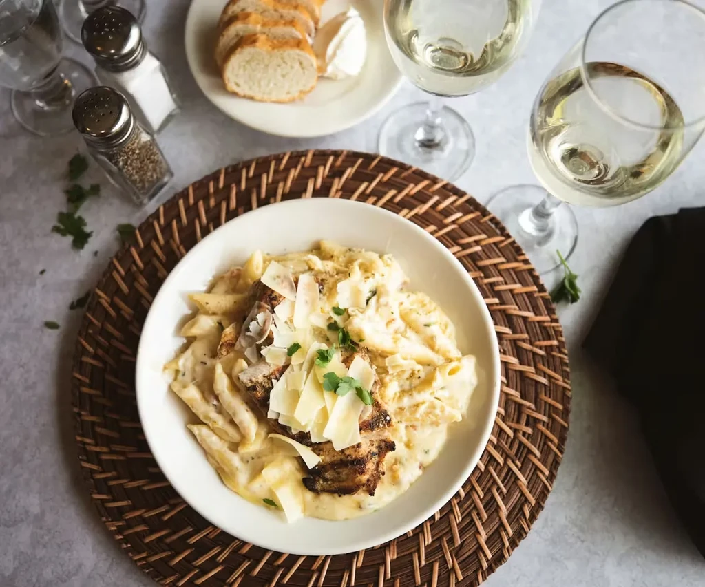 Overhead view: creamy chicken pasta with Parmesan and parsley.