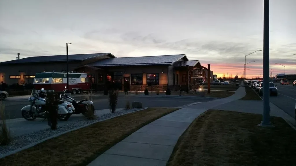 Cayuse Creek Brewing, food truck, and motorcycles under a sunset sky.