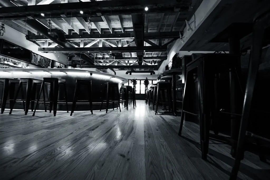 Sophisticated black and white bar with industrial design and Halloween decor.
