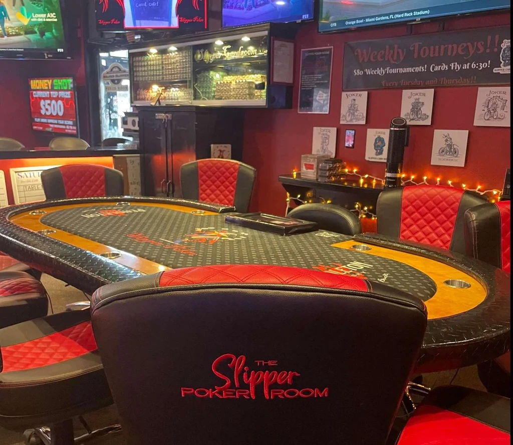Empty Slipper Poker Room with a poker table and tournament banner.