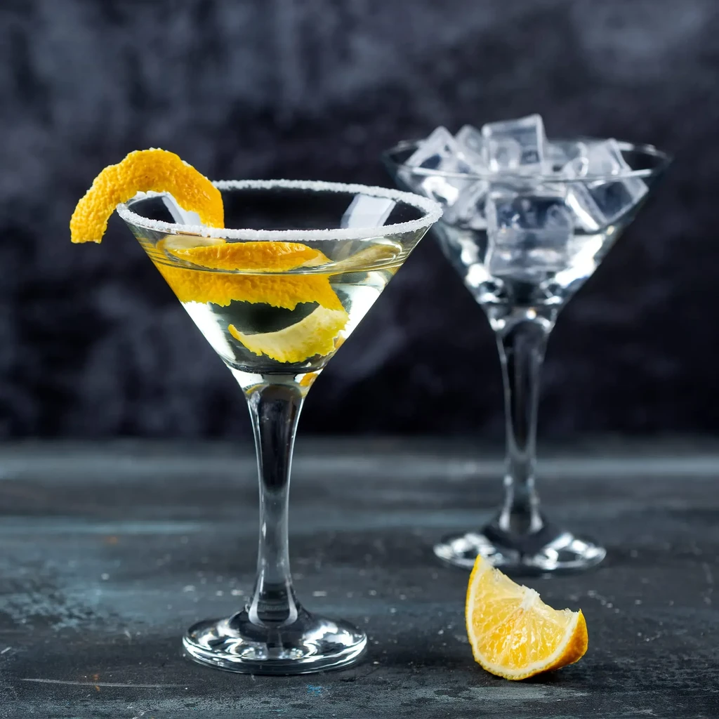 Sugar-rimmed martini with lemon peel; another martini glass of ice.