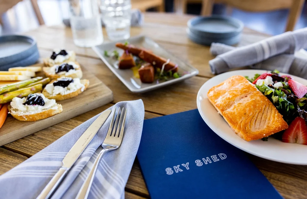 Close-up of a dining table with salmon, crostini, and savory dishes.