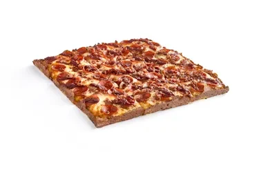 Square meat pizza with pepperoni, sausage, and melted cheese on white.