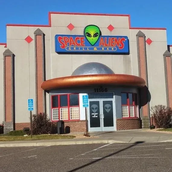 Themed Space Aliens Grill & Bar exterior with a flying saucer entrance.