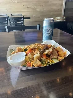 Grilled chicken salad in a paper boat with Busch Light beer.