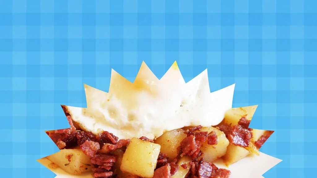 Stylized breakfast of potatoes, bacon, fried egg in a star cutout.