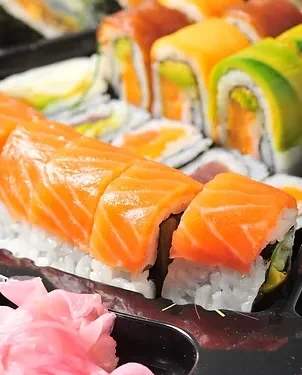 Salmon maki sushi and pickled ginger in a black takeout tray.