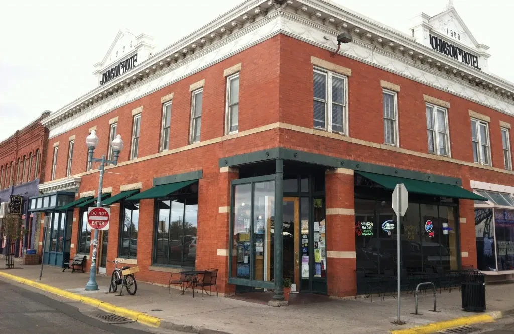 Red brick Johnson Hotel (1900) with ground-floor Grill & Cafe.