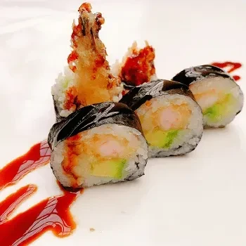 Sushi rolls with shrimp, avocado, and sauce on a white plate.