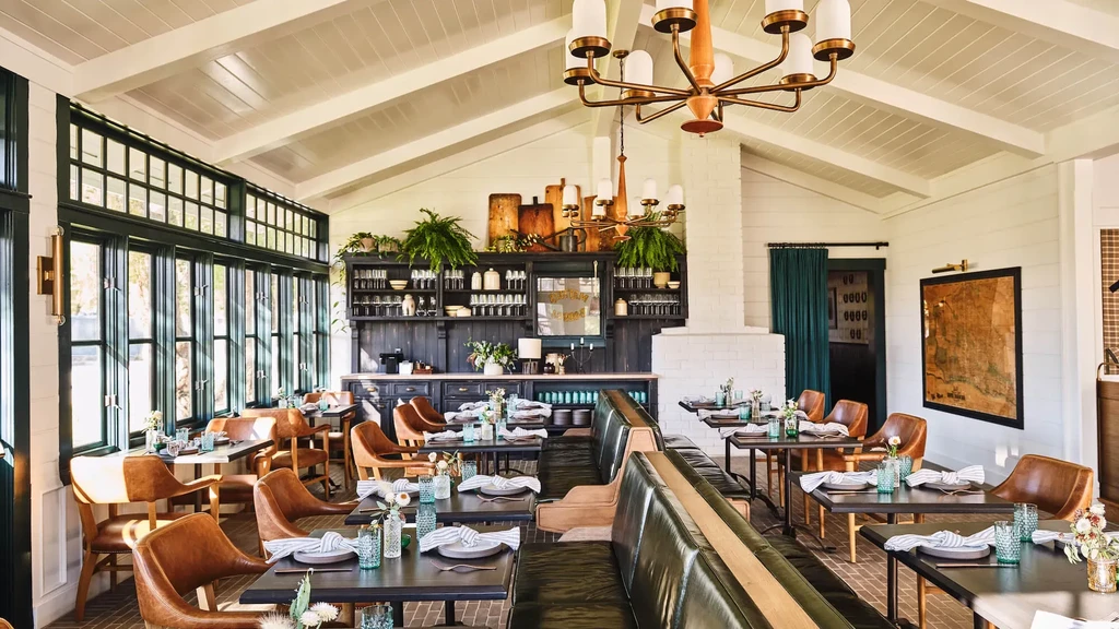 Empty, elegant restaurant dining room with vaulted ceilings and stylish bar.