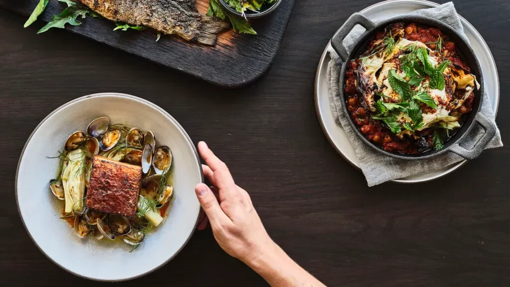Three distinct dishes: seared protein, grilled fish, and chickpea skillet.