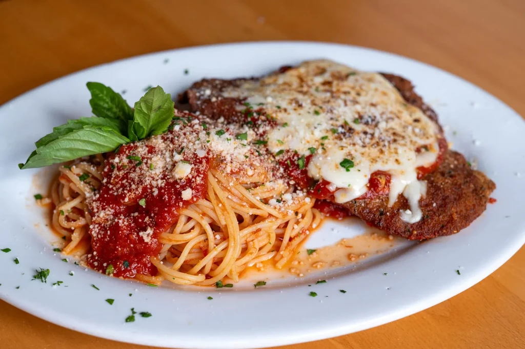 Spaghetti marinara and a cheesy breaded chicken or veal cutlet.