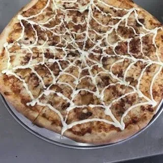 Overhead pizza with white spiderweb sauce, cheese, and meat.