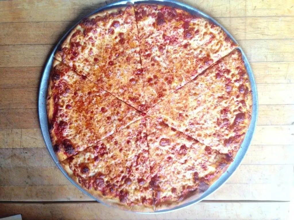 Freshly baked, sliced cheese pizza with bubbly melted cheese.