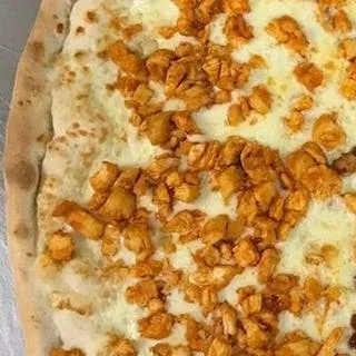 Overhead view of a flatbread with melted cheese and spiced chicken.