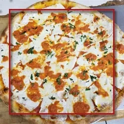 A square of pizza with fresh mozzarella and dollops of red sauce.