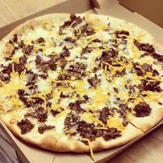 A whole cheeseburger pizza with ground beef and cheddar in a cardboard box.