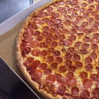 Large, round pepperoni pizza in a cardboard box, viewed from above.