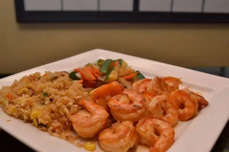 Plate of shrimp, fried rice, and mixed vegetables.