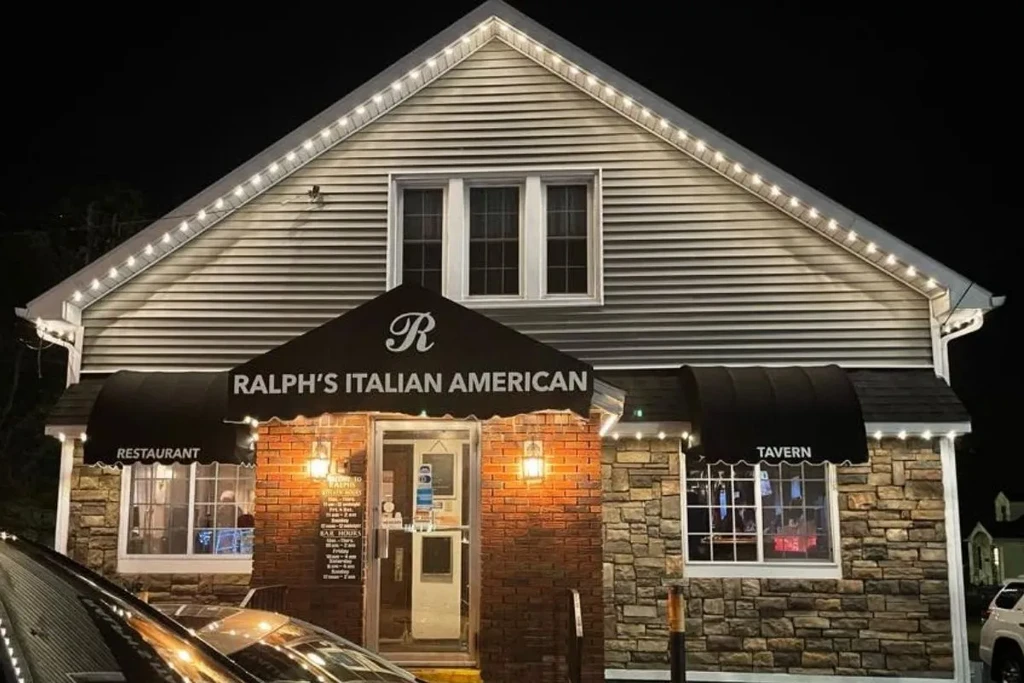 Ralph's Italian American restaurant and tavern illuminated at night.