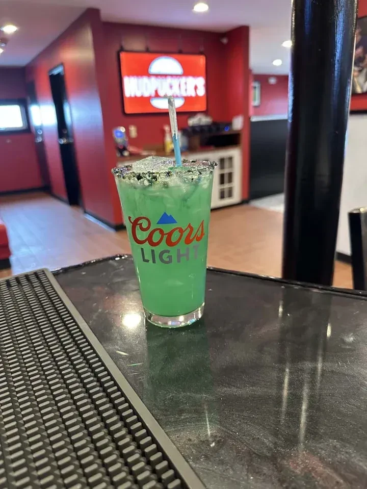 Green drink in a Coors Light cup at Mudpucker's bar.