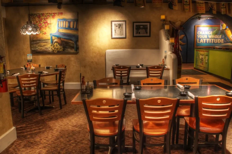 Empty restaurant dining area with warm walls and rustic decor.