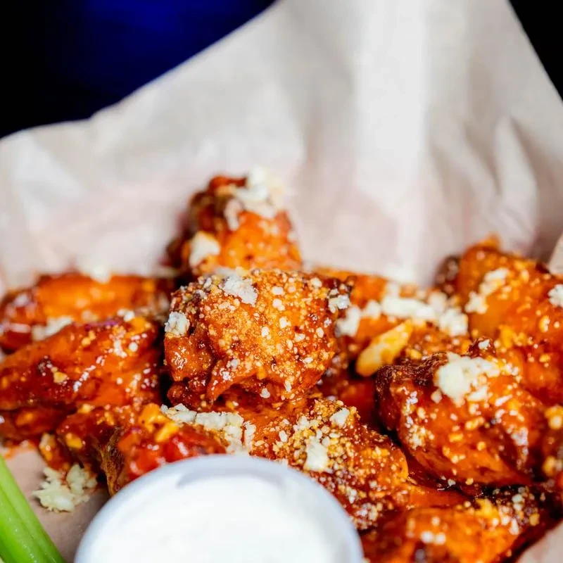 Buffalo chicken wings with crumbled blue cheese, celery, and ranch dip.