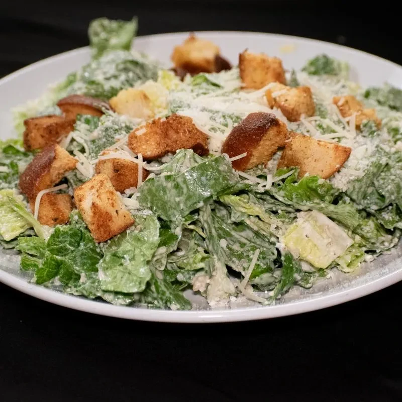 Caesar salad with romaine, creamy dressing, croutons, and Parmesan.
