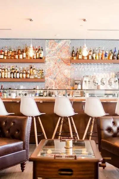 A stylish, well-stocked bar area with lounge seating and modern stools.